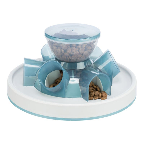 Feeder with transparent container and blue tubes, filled with dry food. Slow feeding design.