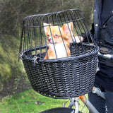 Bicycle basket made of black wicker with metal grid cover, mounted on the handlebar. Suitable for transporting small pets.