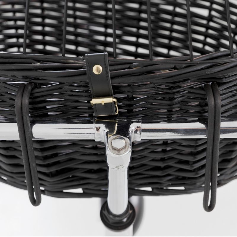 Close-up of a black basket made of woven material with metal holder and leather strap with gold buckle.