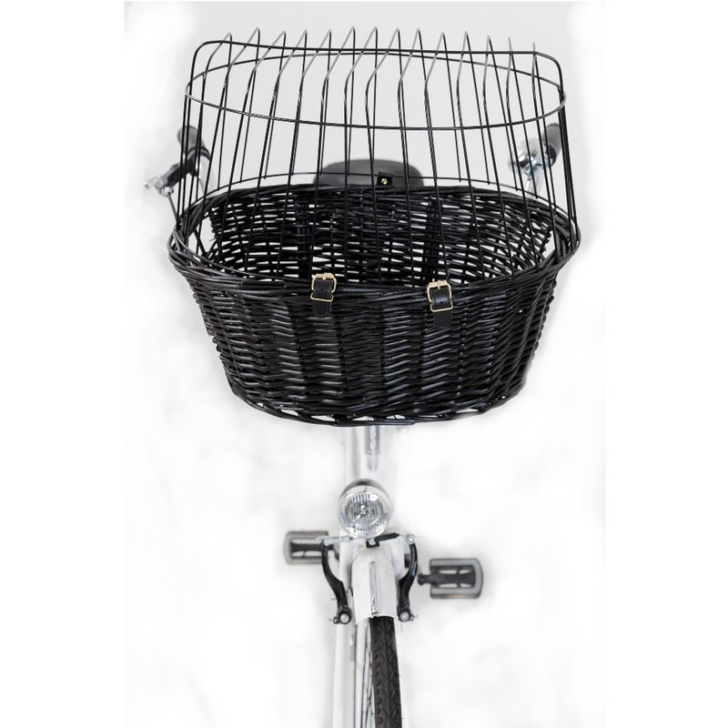 Black woven bicycle basket with metal grid cover and two buckles for attachment, mounted on a bicycle handlebar.