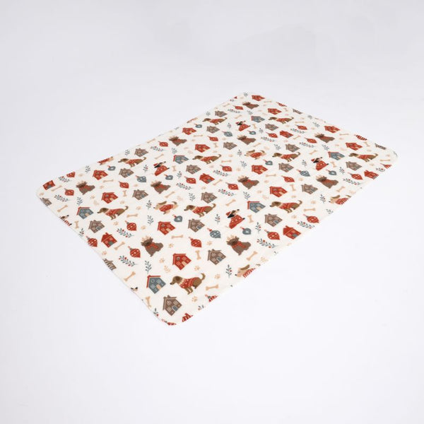 Rectangular blanket with a colourful pattern of dog kennels, bones and dogs on a cream-coloured background.