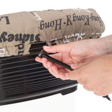 Hand tightens a black drawstring on a brown cover with a script pattern, placed over a black plastic container.