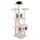 Beige scratching post with multiple levels, caves, platforms and toy mice. Black cat lying on top platform.