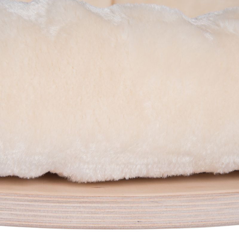 Close-up of soft, cream-coloured plush material on a wooden base.