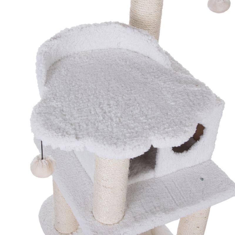 Cat tree with white plush cover, cave and platform. Sisal-wrapped posts and hanging toy visible.