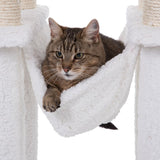 Cat lying in a white plush hammock, attached between two scratching posts with sisal.