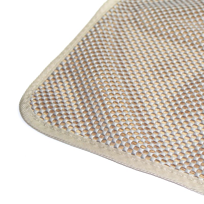Close-up of a beige-grey mat with non-slip texture and woven edge.