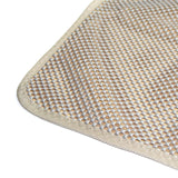 Close-up of a beige-grey mat with non-slip texture and woven edge.