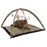 Play mat with leopard pattern and play arch, hanging toys such as mouse, ball and feather. Cat lying on the mat.