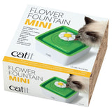 Catit Flower Fountain Mini, drinking fountain for fresh water with included filter, capacity 1.5 l. Shown: cat drinking from green fountain with flower attachment.