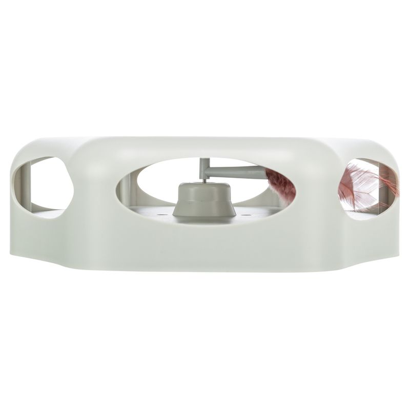 Toy with white plastic casing and integrated spring, visible through oval openings.