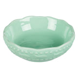 Green ceramic bowl with wavy rim and embossed fish motifs on the outside.