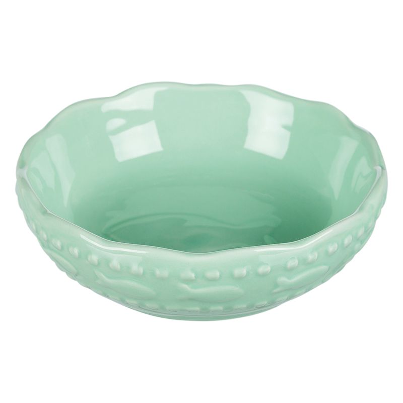 Green ceramic bowl with wavy rim and embossed fish motifs on the outside.