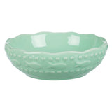 Green ceramic bowl with fish pattern and wavy rim, suitable for food or water.