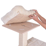Demonstration of the removable cushion on a wooden platform of a scratching post. Cushion is lifted by hands, Velcro fastenings for attachment are visible.