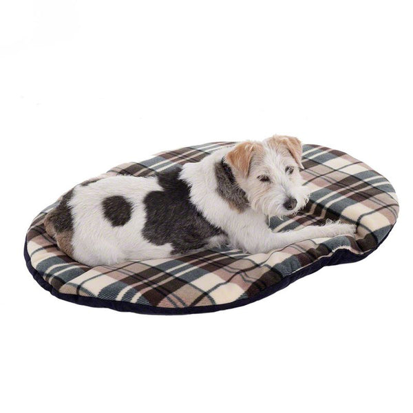 Dog lying on an oval dog cushion with a checked pattern in beige, brown and dark green.