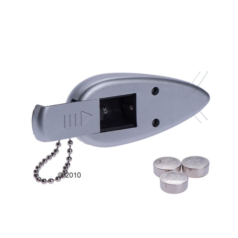 Grey clicker training device with metal chain and three round batteries. The year ©2010 is visible on the side.