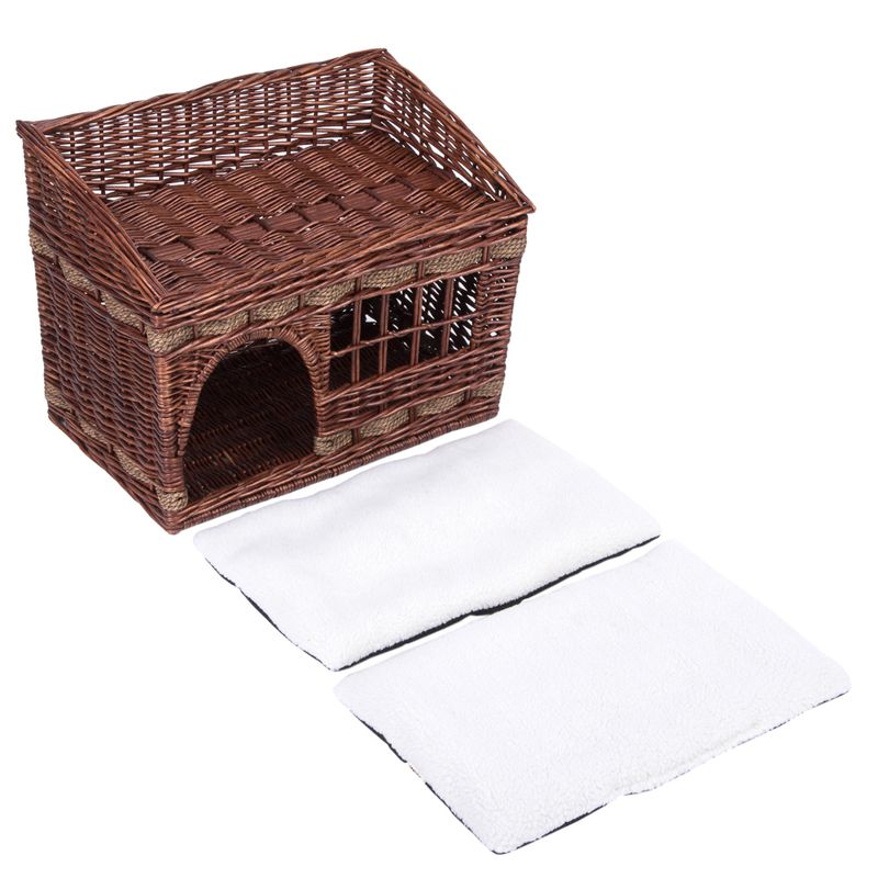 Braided brown basket in house shape with window and entrance, includes two white cushions.