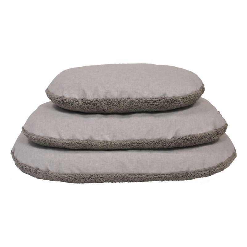 Three grey, oval cushions with soft edges in different sizes, stacked on top of each other.