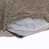 Close-up of a grey pet cushion with removable cover and visible inner filling made of mesh material.