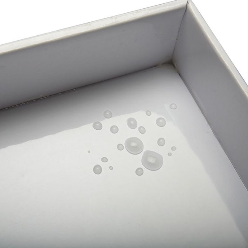 Close-up of water droplets on a smooth tray surface, showing its water-resistant or easy-clean feature.