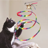 Play wand with gold-coloured star and colourful ribbon, played with by a black and white cat.