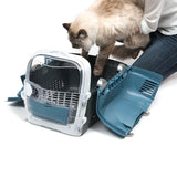 Transport box with side-opened door, cat being placed inside. Suitable for pet transport and easy handling with folding mechanism.
