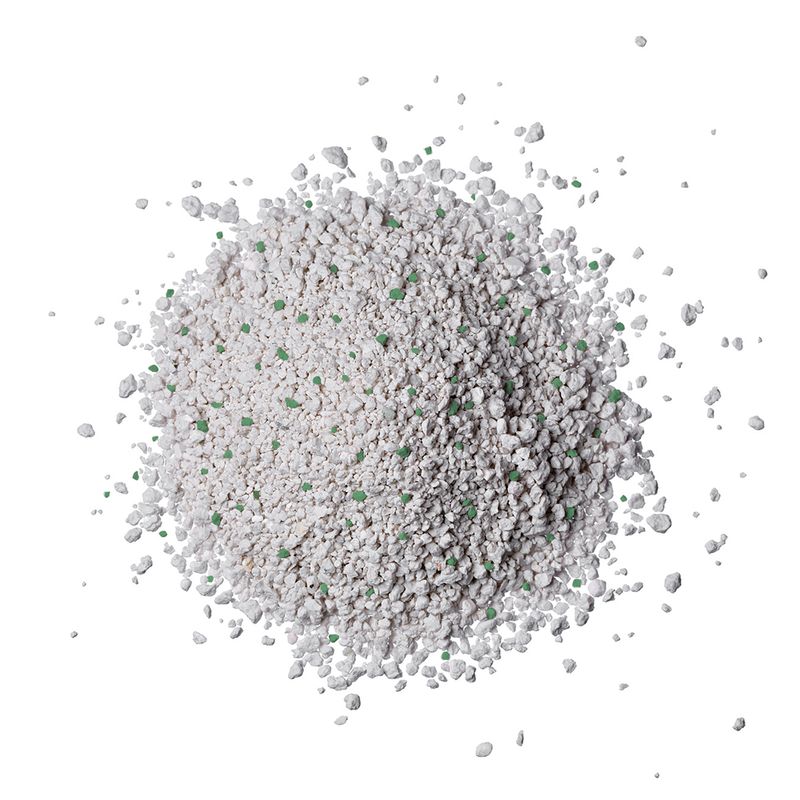 White, granular litter with green particles, suitable for use as cat litter.