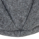 Close-up of grey felt material with visible seams, possibly part of a pet product.