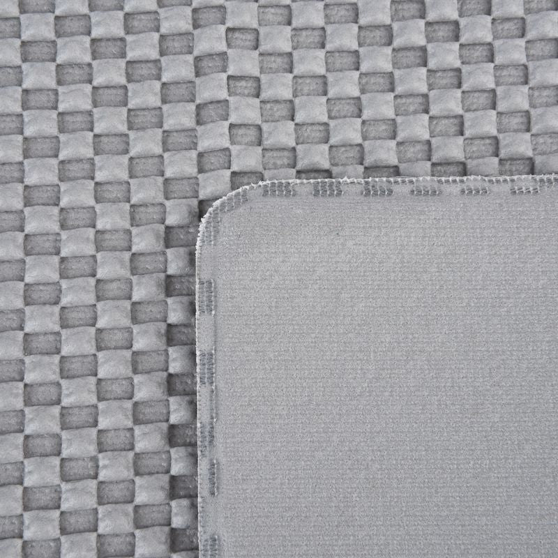 Close-up of grey, textured fabric with woven pattern and smooth edge. Shows material details for product description.