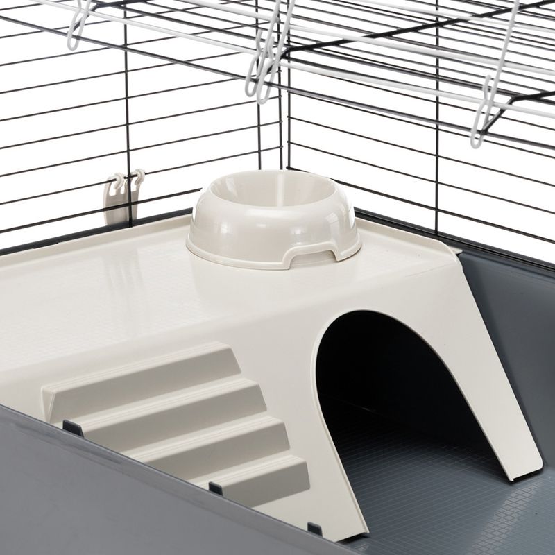 Small animal cage with plastic platform, integrated feeding bowl, ramp and shelter. Metal grid with visible hook closure.