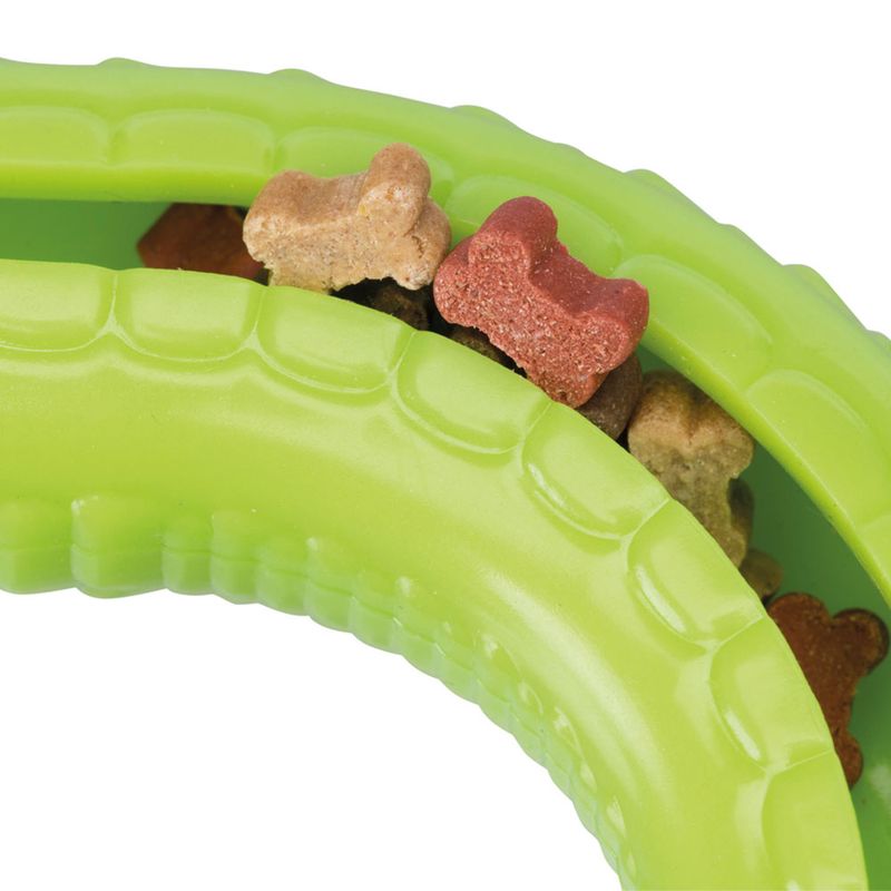 Green toy with bone-shaped treats in various colours, including red, brown and beige.