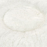 Close-up of a white, fluffy material, possibly for a pet bed or blanket.