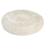 Round, plush, cream-coloured pet bed with raised edges and a soft, fluffy surface, shown from above to display its shape and texture.