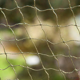Close-up of sturdy mesh fabric made of green material, suitable for various outdoor applications.