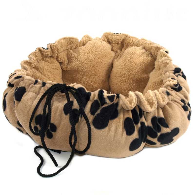Round, beige pet bed with black paw patterns and adjustable drawstring. Softly padded inside for comfort.