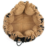 Round, beige cuddly bed with soft fabric and adjustable drawstring. Ideal for pets to sleep or relax.