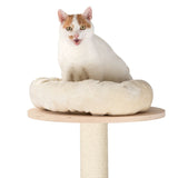 White cat sitting on a beige, padded lounging cushion attached to a wooden platform of a scratching post.