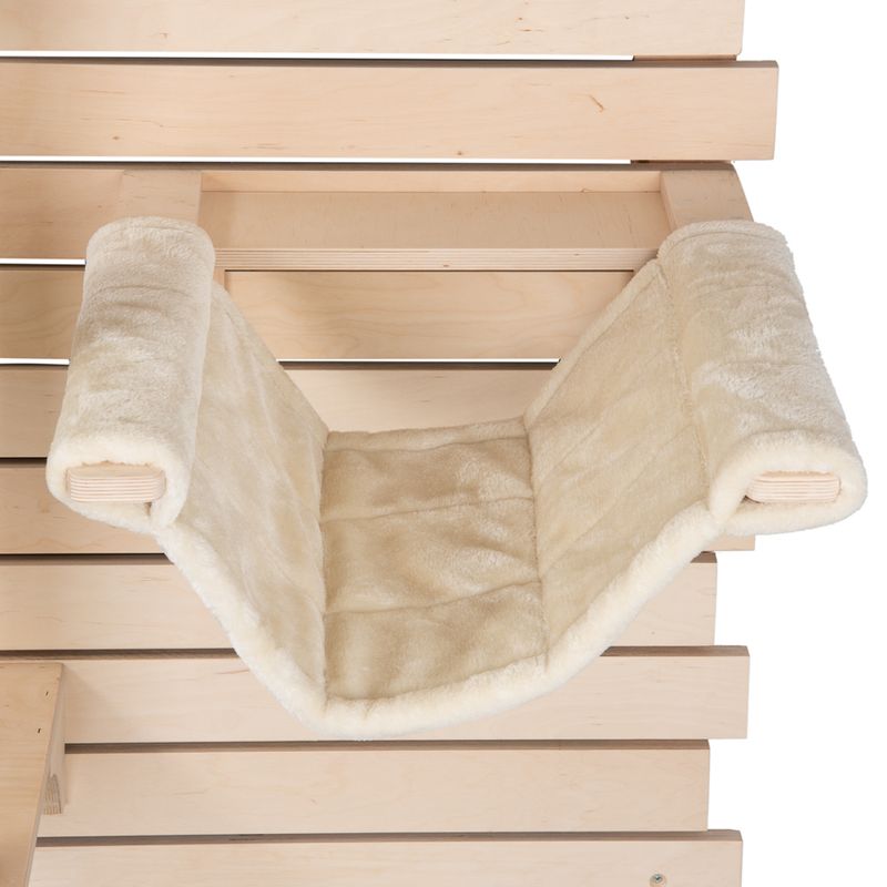 Hammock made of beige plush with wooden frame, attached to a wooden structure.