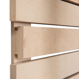 Close-up view of wooden panels with tongue and groove joint, light wood grain visible.