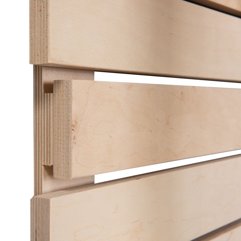 Close-up view of wooden panels with tongue and groove joint, light wood grain visible.