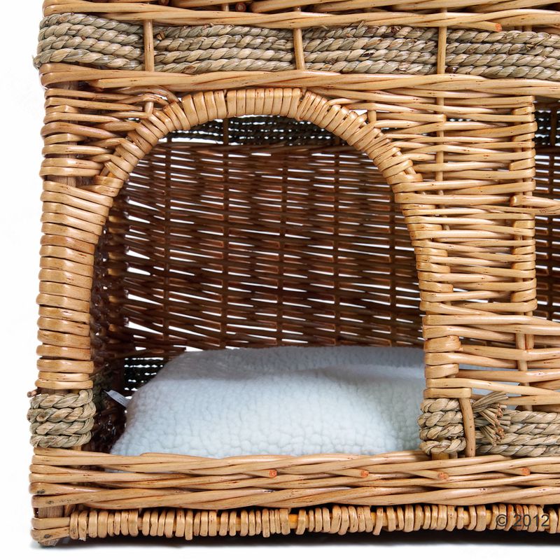 Braided basket with a white, soft cushion inside. Suitable as a sleeping place or retreat.