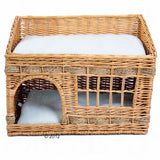 Braided rattan basket with two levels, white padded lying surfaces and an entrance on the lower level.