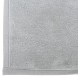Grey fabric with a soft surface and visible seam at the edge.
