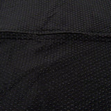 Close-up of a black, non-slip material with small studs for better grip.