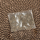 Transparent pouch with dried herbs on a brown, honeycomb-shaped cardboard base.