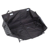 Black car seat cover with hook-and-loop fasteners and straps, suitable for protecting the back seat. Kleinmetall brand name visible on labels.