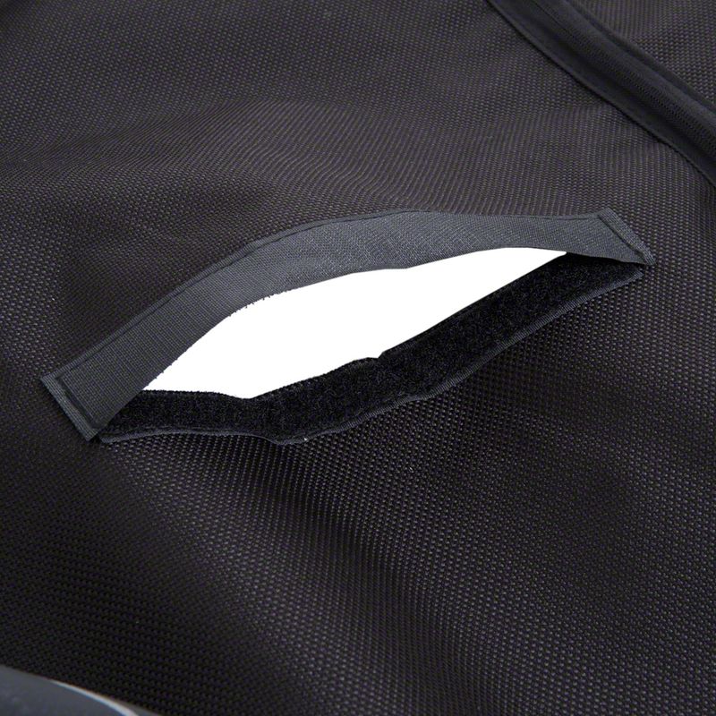 Close-up of black fabric material with hook-and-loop fastener opening, suitable for secure closure or storage.