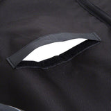 Close-up of black fabric material with hook-and-loop fastener opening, suitable for secure closure or storage.