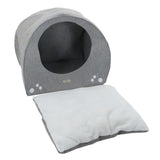Grey, round pet bed with removable white cushion and decorative paw prints on the front.